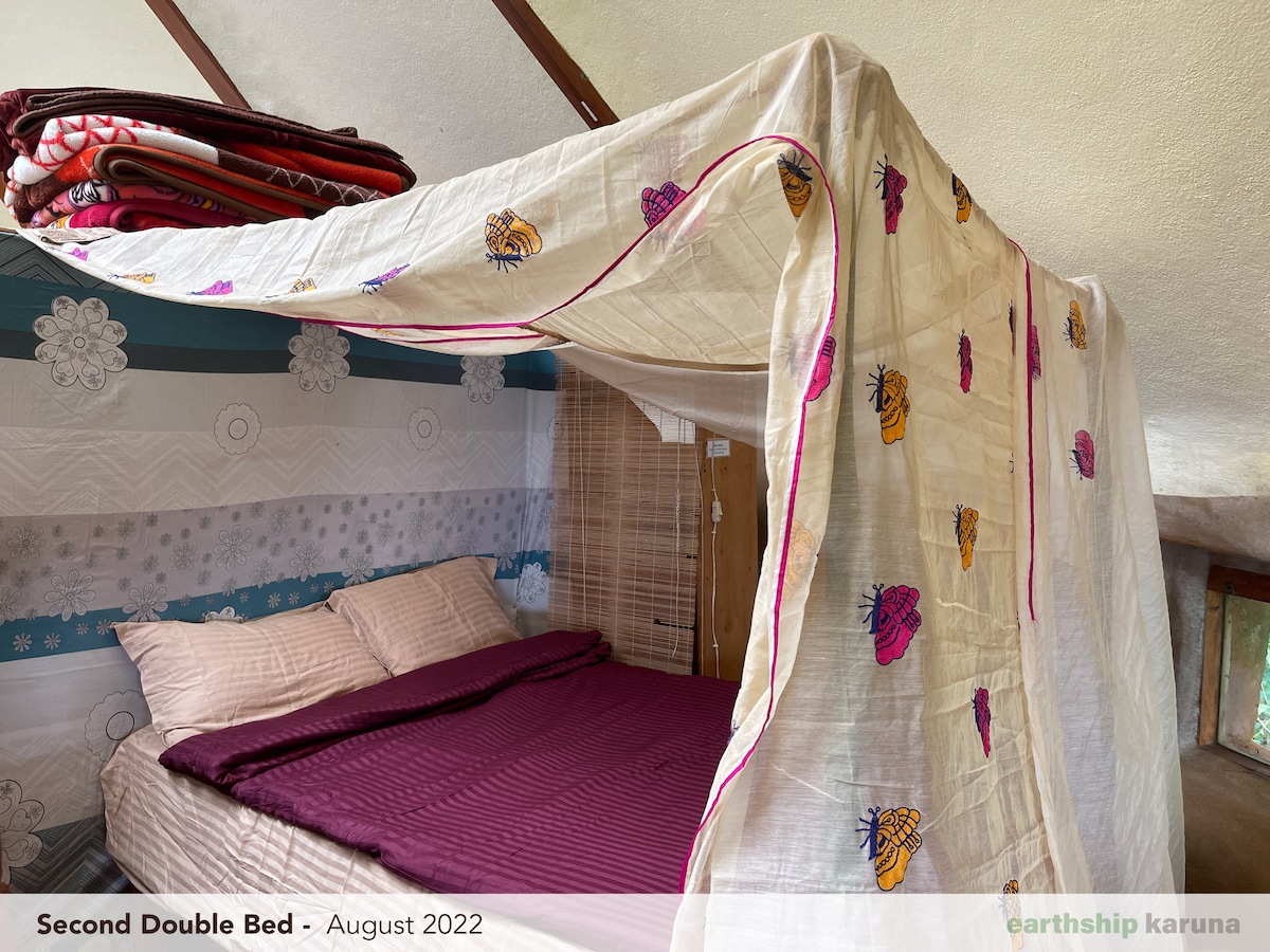 Second bedroom with a double bed and draped canopy