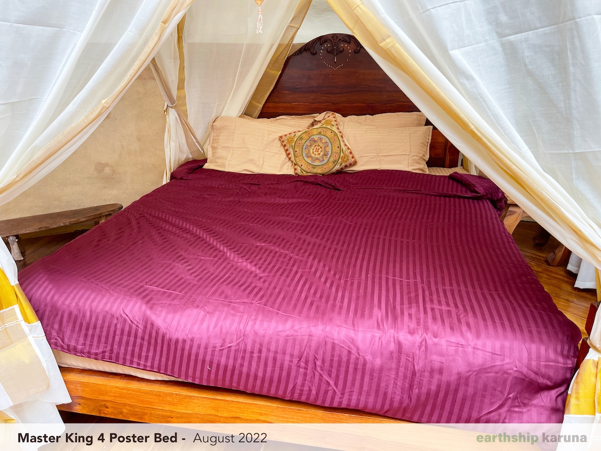 Master bedroom with a king-size four-poster bed