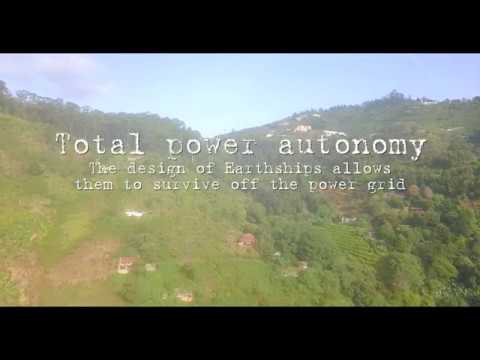 Aerial view of Earthship Karuna — drone shot of the round hand-built home against the mountains above Kodaikanal